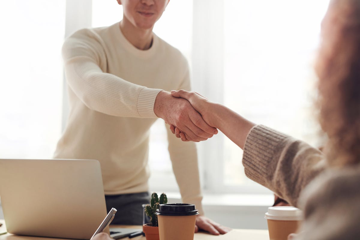 Two partners shaking hands after an agreement
